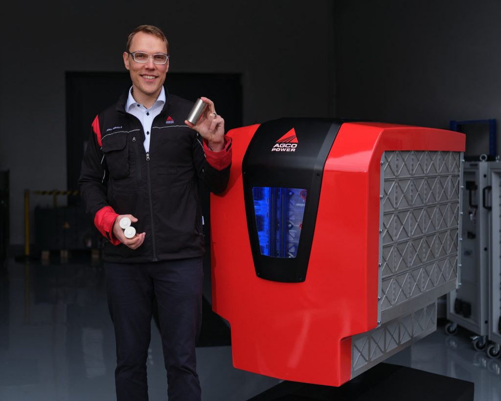 Juha Heikkilä, Manager Electrification, holds NMC battery cells used in the prototype battery. The battery, designed by AGCO Power, contains a total of 1400 cells and offers 150 kWh of capacity.
